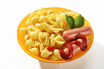 Cooked macaroni shells with sausages and sauce in orange plate on white background. Close up, high resolution product.
