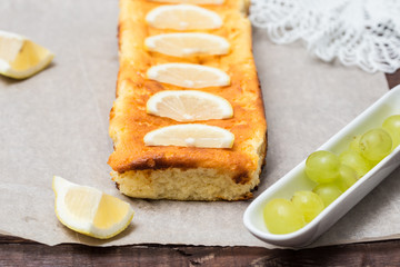 cottage cheese pie is decorated with lemon and grapes