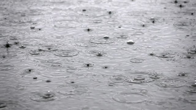 Slow motion of heavy rain on the water surface. Closeup shot of nature scene with meditative and hypnotic effect. Full HD footage 1920x1080
