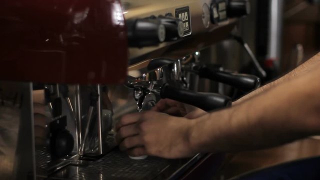 Barista prepares two cups of espresso. Medium shot