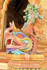 BANGKOK, THAILAND - JUNE 11, 2016 : High Relief Sculpture of dragon monster as porter, door-keeper, decorated with ceramic mosaic at Wat Pariwat Temple, Bangkok, Thailand