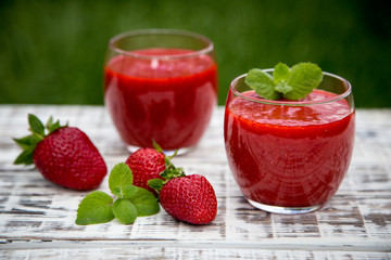 strawberry smoothie on a light wooden background