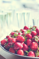 .Dish with strawberries and champagne glasses on the table. Dinner, party, bachelorette party, summer party, celebration. - 113514605