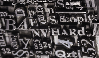 Metal Letterpress Types.
A background from many historic typographical letters in black and white with white background.

