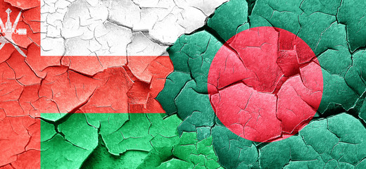 Oman flag with Bangladesh flag on a grunge cracked wall