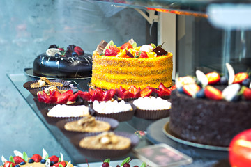 Cakes eclairs and cakes on display in the café. Showcases cafes, restaurants. sweets, desserts on display.