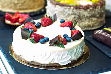 Cakes eclairs and cakes on display in the café. Showcases cafes, restaurants. sweets, desserts on display.