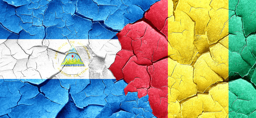 nicaragua flag with Guinea flag on a grunge cracked wall