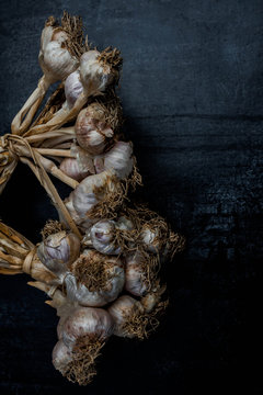 Purple garlic on black wood background,Close up