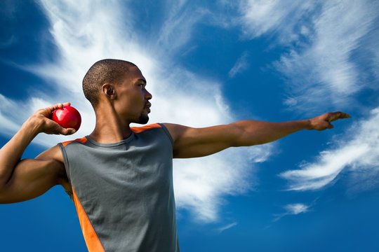 sportsman practising shot put 