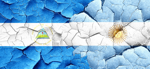 nicaragua flag with Argentine flag on a grunge cracked wall