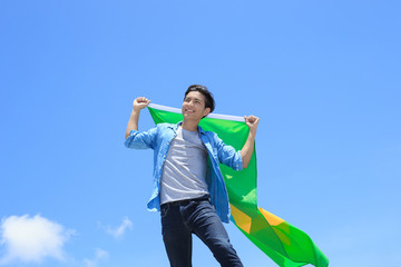 Excited man holding brazil flag