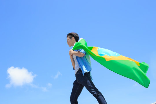 Excited man holding brazil flag