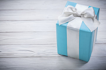 Blue gift box on wooden board celebrations concept