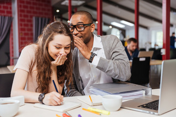 Happy young business people working together and laughing