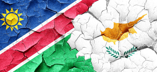 Namibia flag with Cyprus flag on a grunge cracked wall