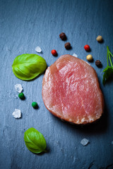 Fresh meat steaks on black slate background. Toned