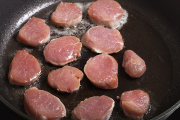 Fresh meat is fried in a frying pan. Selective focus