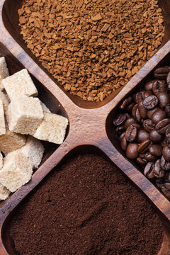 Different kinds of coffee on wooden plate