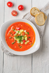 Vegetable soup gazpacho, stand, cherry tomatoes, white bread on