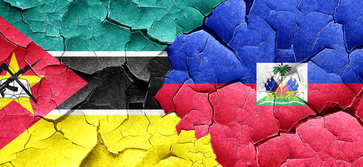 Mozambique flag with Haiti flag on a grunge cracked wall