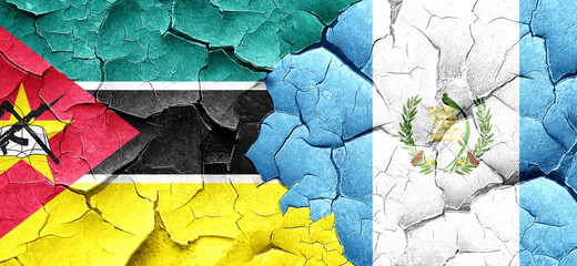 Mozambique flag with Guatemala flag on a grunge cracked wall