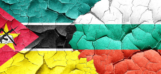 Mozambique flag with Bulgaria flag on a grunge cracked wall