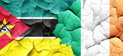 Mozambique flag with Ireland flag on a grunge cracked wall
