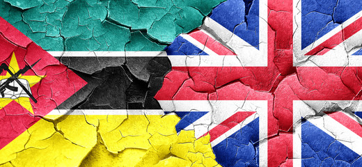 Mozambique flag with Great Britain flag on a grunge cracked wall