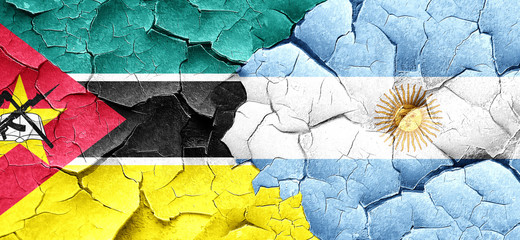 Mozambique flag with Argentine flag on a grunge cracked wall
