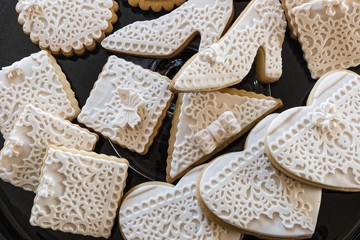 White butter cookies in various shapes on glass dish