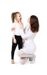 Doctor examining throat of little girl