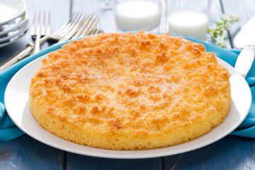 coconut tarte on white plate in blue wooden background