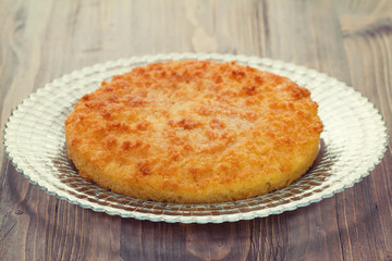 coconut tarte on dish on brown wooden background