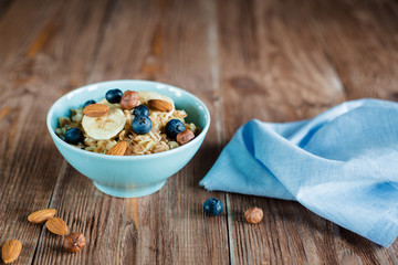 Oatmeal porridge breakfast with nuts and berries