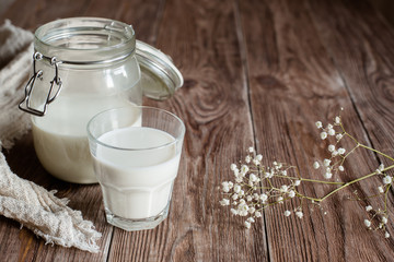 Jur and glass with milk on wooden background. rustik style