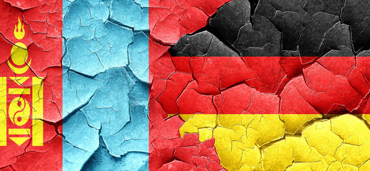 Mongolia flag with Germany flag on a grunge cracked wall