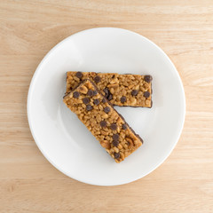 Chocolate chip peanut protein bars top view on a plate atop a wood table.