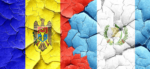 Moldova flag with Guatemala flag on a grunge cracked wall