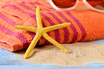 starfish, sunglasses and beach towel