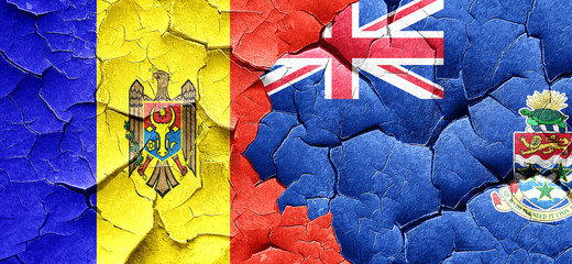 Moldova flag with Cayman islands flag on a grunge cracked wall