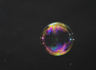 Soap bubble isolated on a dark background.