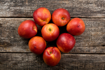 The simple food composition with nectarines on the unique backing closeup 