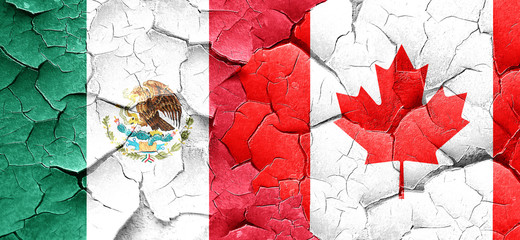 mexico flag with Canada flag on a grunge cracked wall