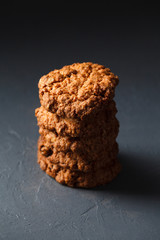Close-up photo of oatmeal cokies stack on gray background