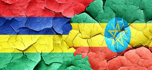 Mauritius flag with Ethiopia flag on a grunge cracked wall