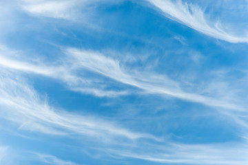 Cirrus clouds in the blue sky of Crete. The clouds looks like thin, wispy strands, The photo is taken on Crete, Greece, The clouds forms in altitudes above 5,000 m