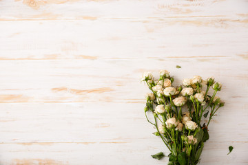 Tender bouquet of roses on wood table. Copy space