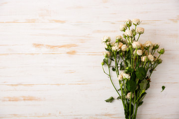 Tender bouquet of roses on wood table. Copy space