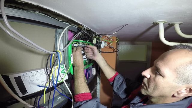 Electrician Turning On New Trip Switch Fuses in a Mains Fuse Box / Experienced electrician turning on the automatic circuit breakers HD1080p